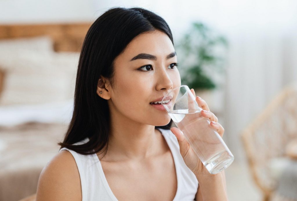young-asian-girl-drinking-water-at-bedroom-at-home.jpg